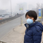 A boy standing with smog